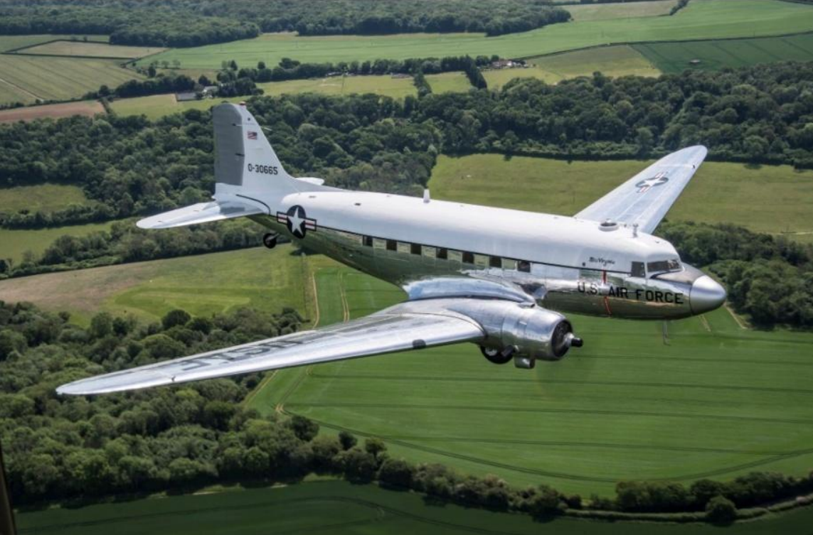 Historic Air Force One aircraft in flight above the landscape
